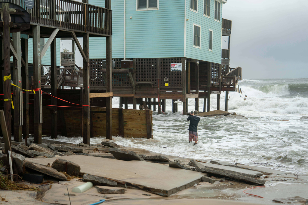 Dozens rescued as remnants of typhoon hits Alaska while nor’easter brings flooding to East Coast